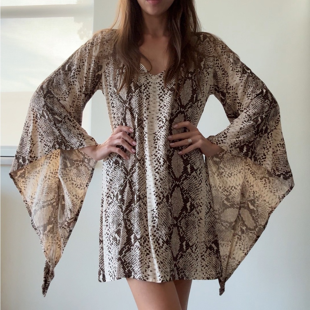Dress with wild pattern. Small size. Cocktail dress with wide sleeves.